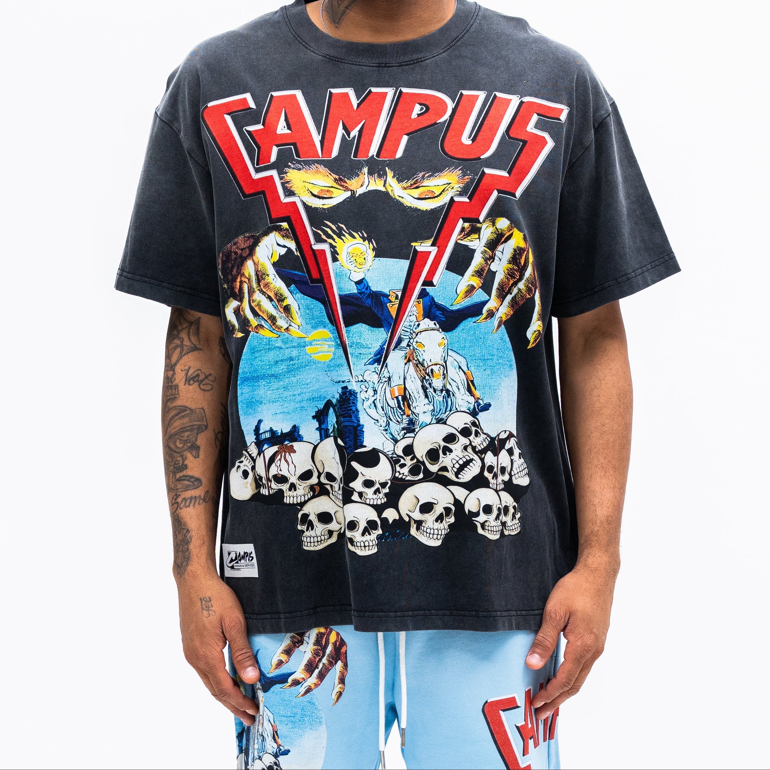 Person wearing a graphic t-shirt with 'CAMPUS' text and colorful design on a white background
