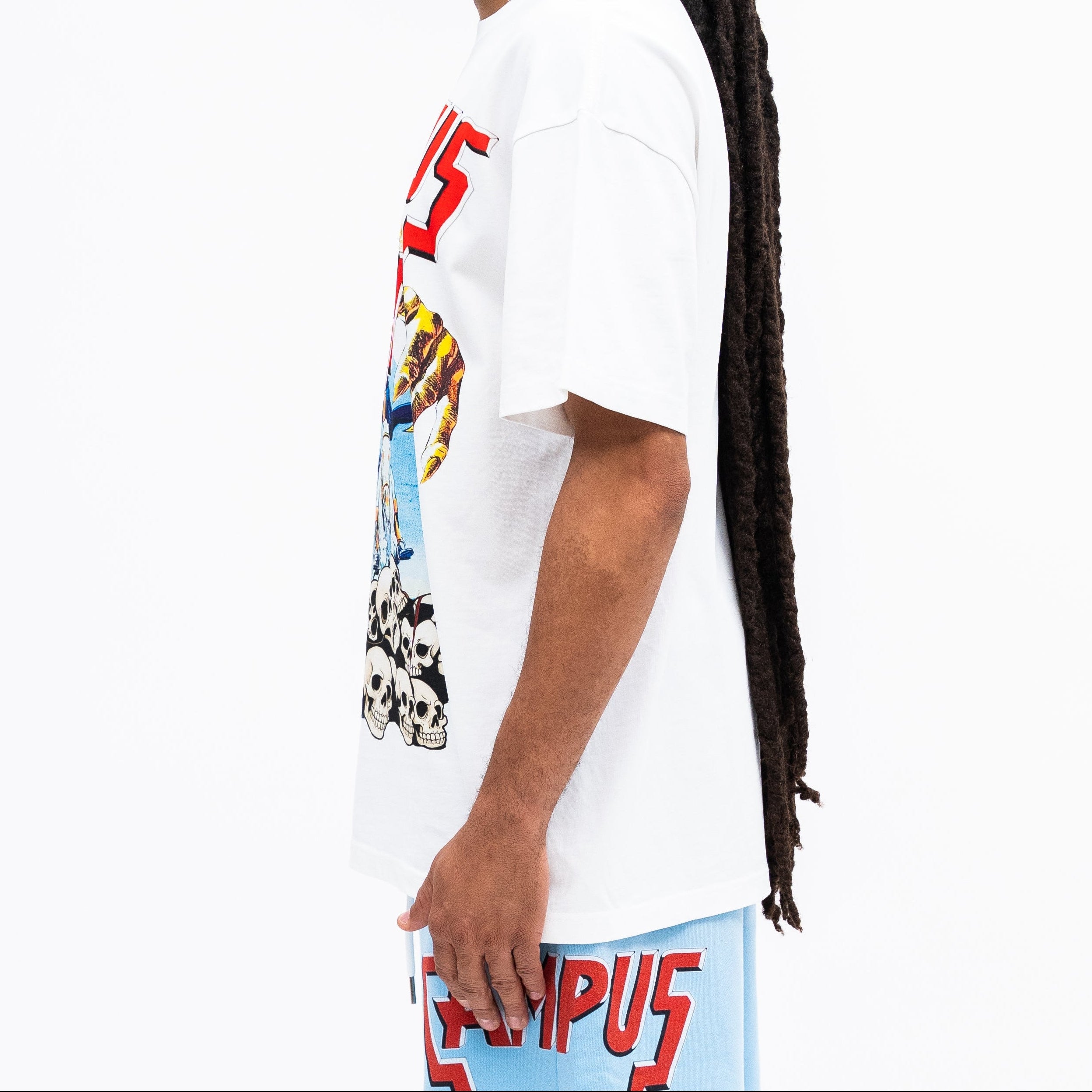 Person wearing a white t-shirt with colorful graphics and text, standing against a white background.