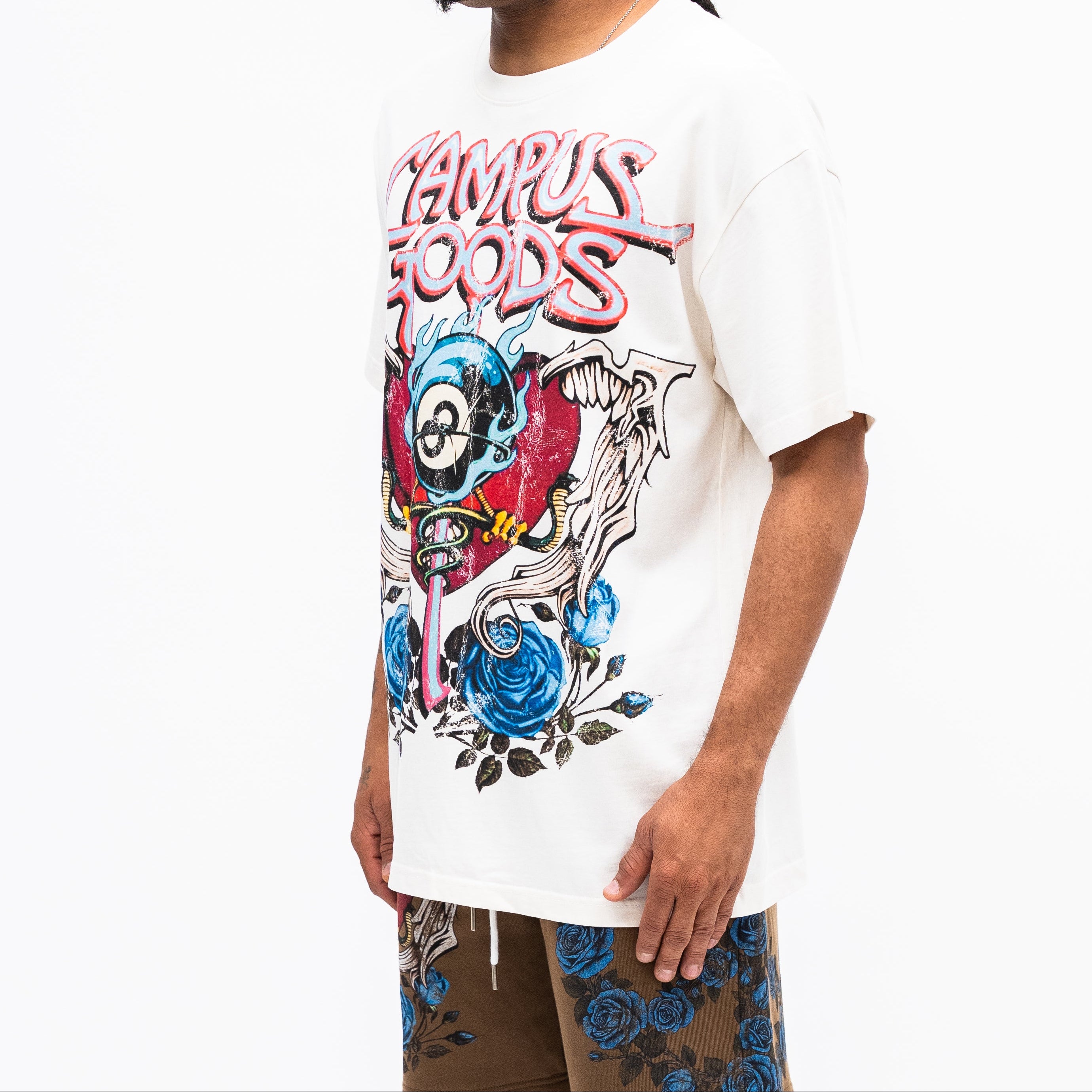 Person wearing a white t-shirt with colorful graphics and text on a white background