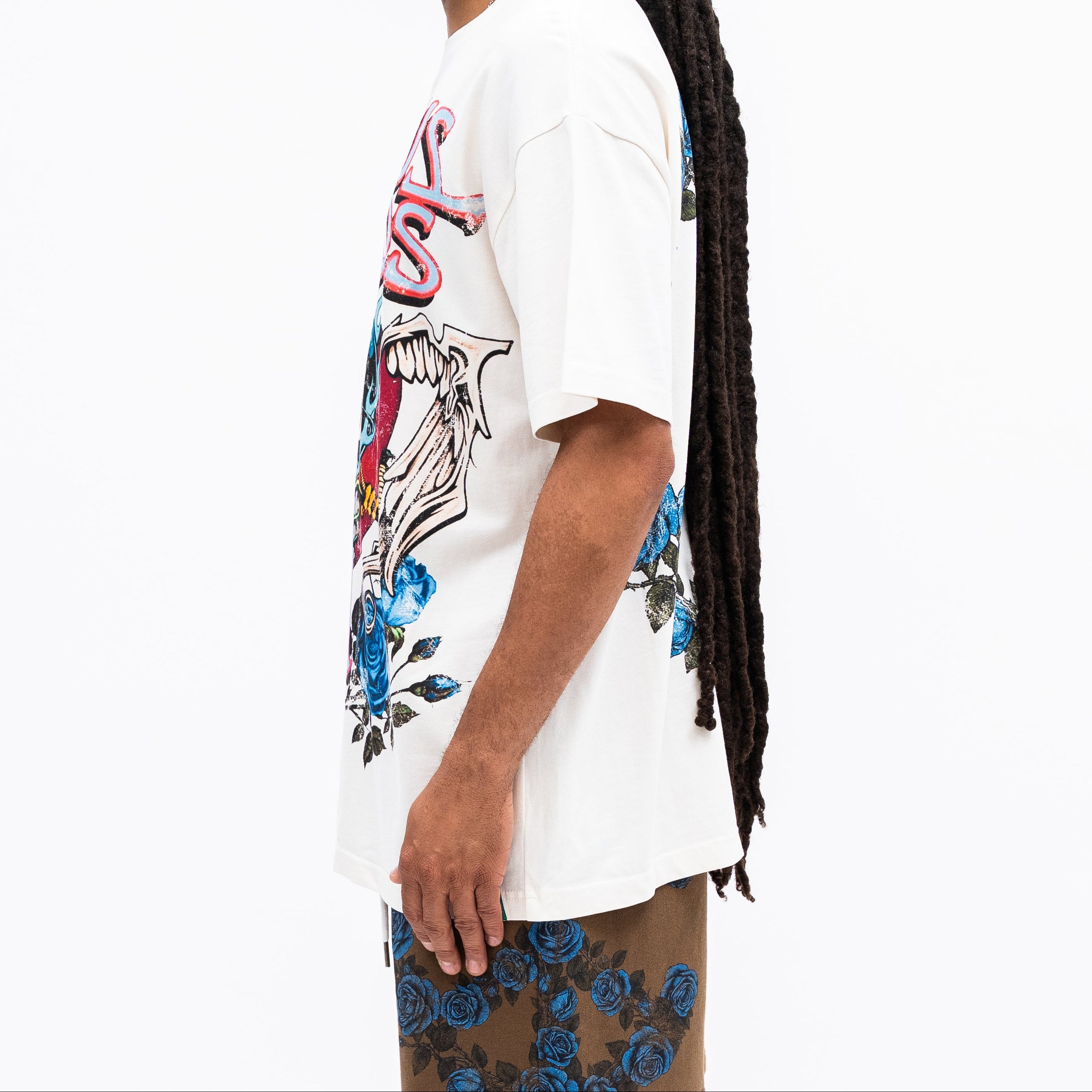 Person wearing a white t-shirt with colorful graphics on a white background