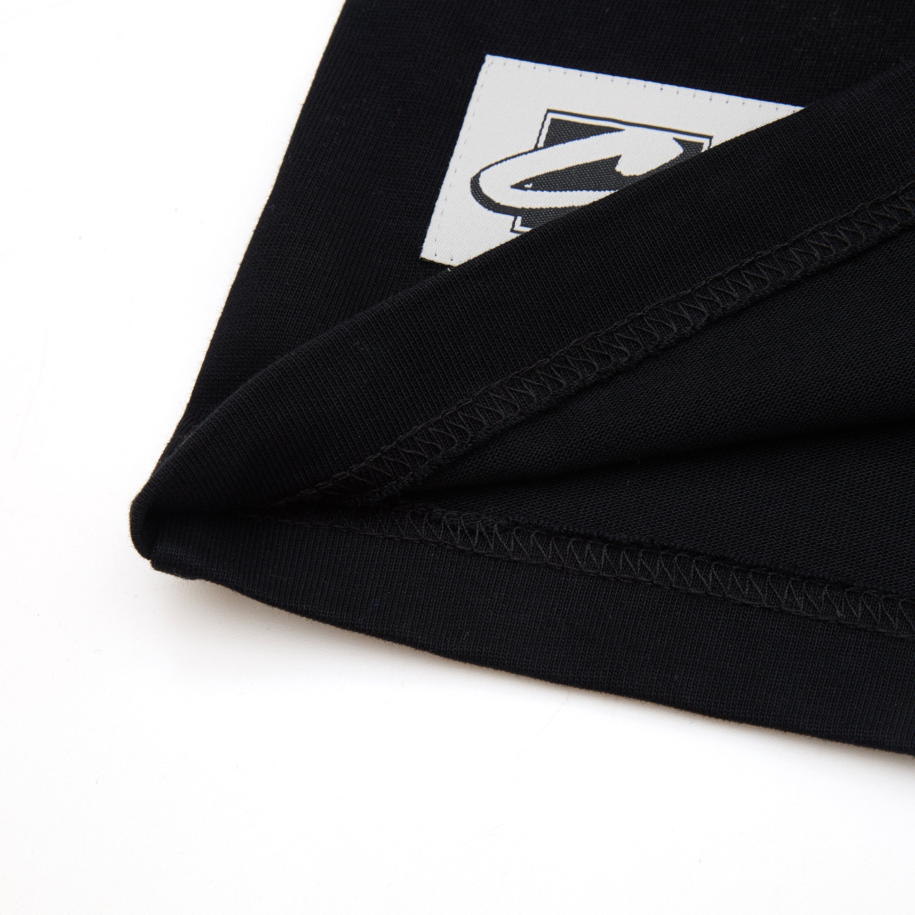 Close-up of a black fabric with a logo on a white background