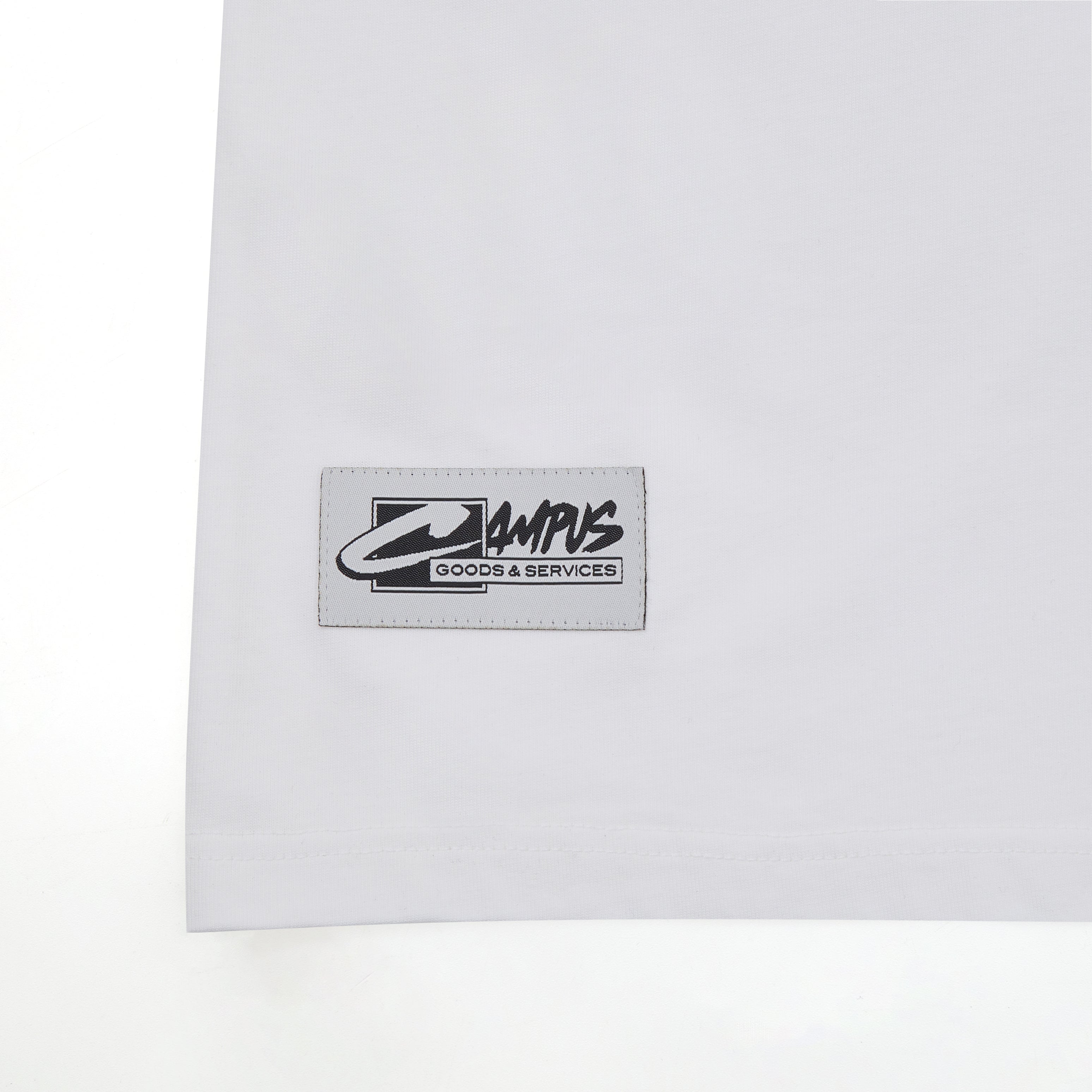 White shirt with a logo patch on a white background