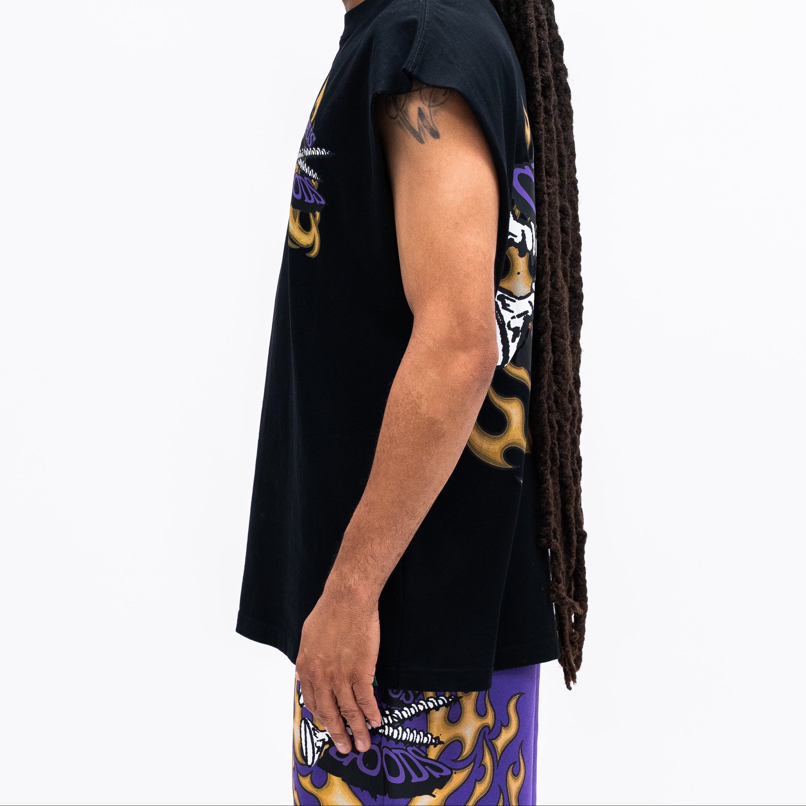 Person wearing a black t-shirt with colorful graphics on a white background