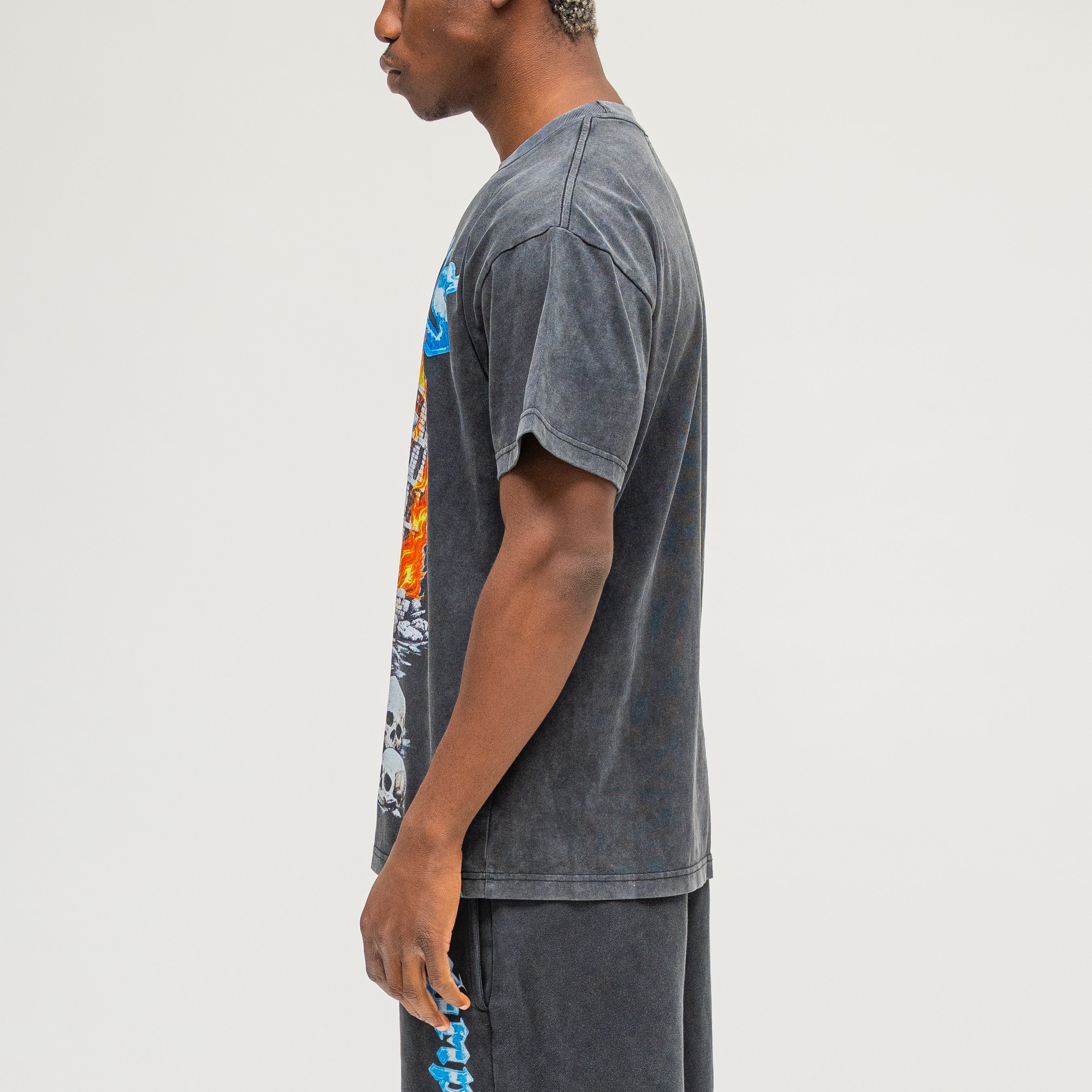 Campus Goods Chopper Tee Black – side angle on model showing skull biker graphic and oversized fit