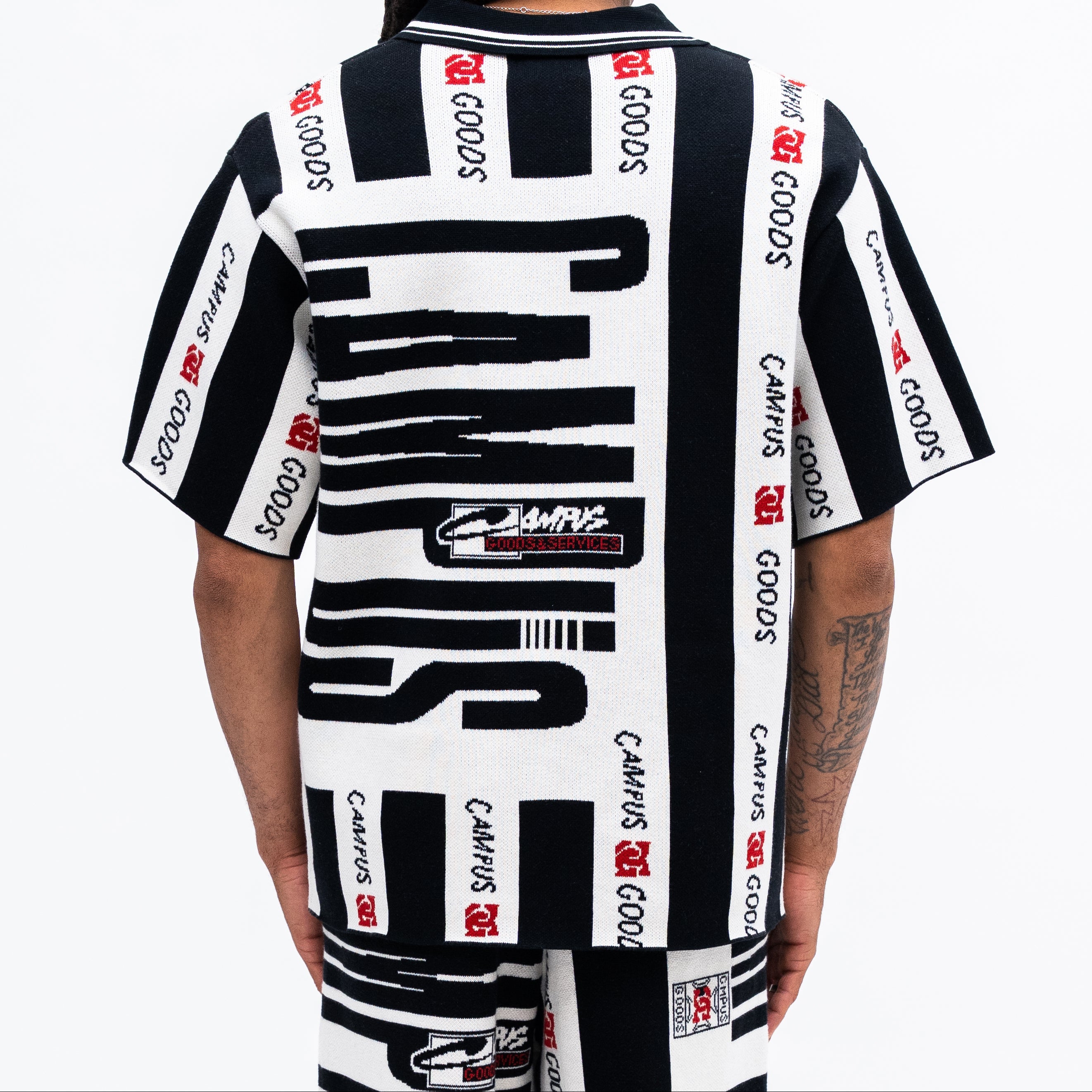 Person wearing a black and white striped shirt with CAMUS GOODS branding on a white background