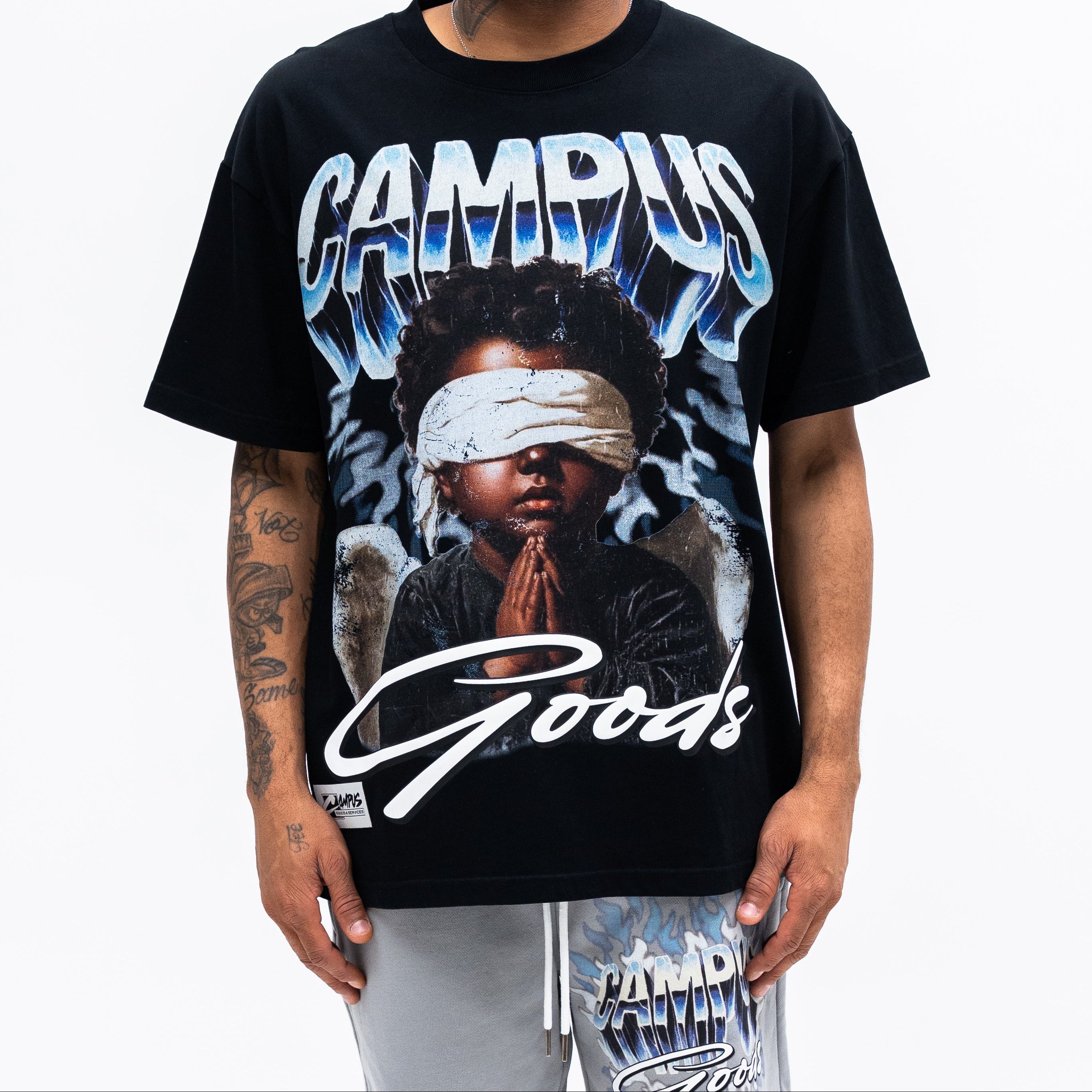 Person wearing a black t-shirt with graphic design and text