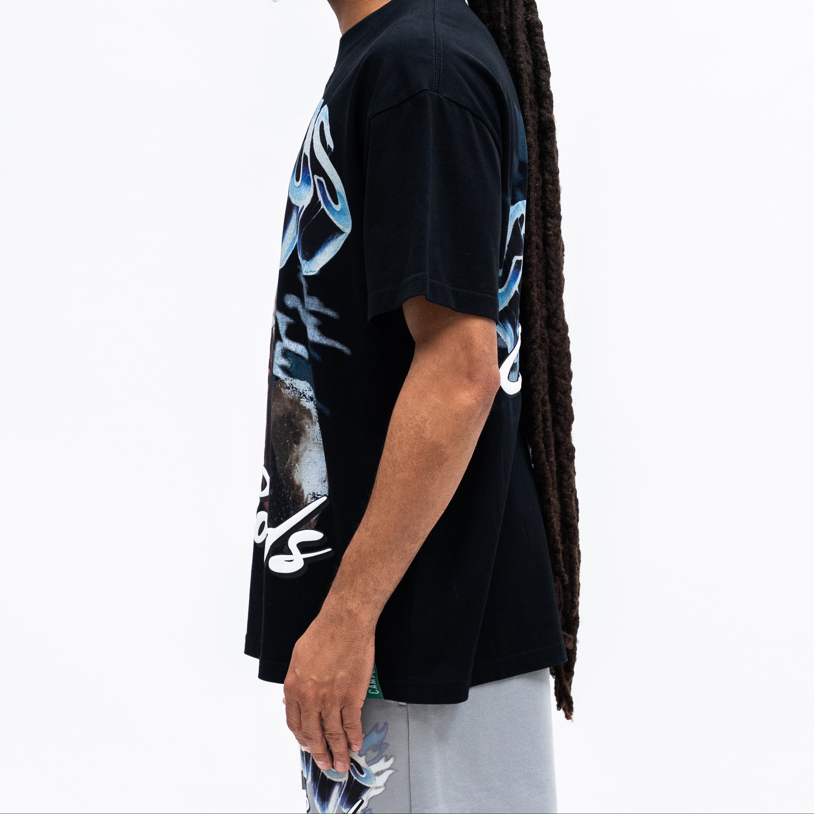 Person wearing a black t-shirt with graphic design on a white background