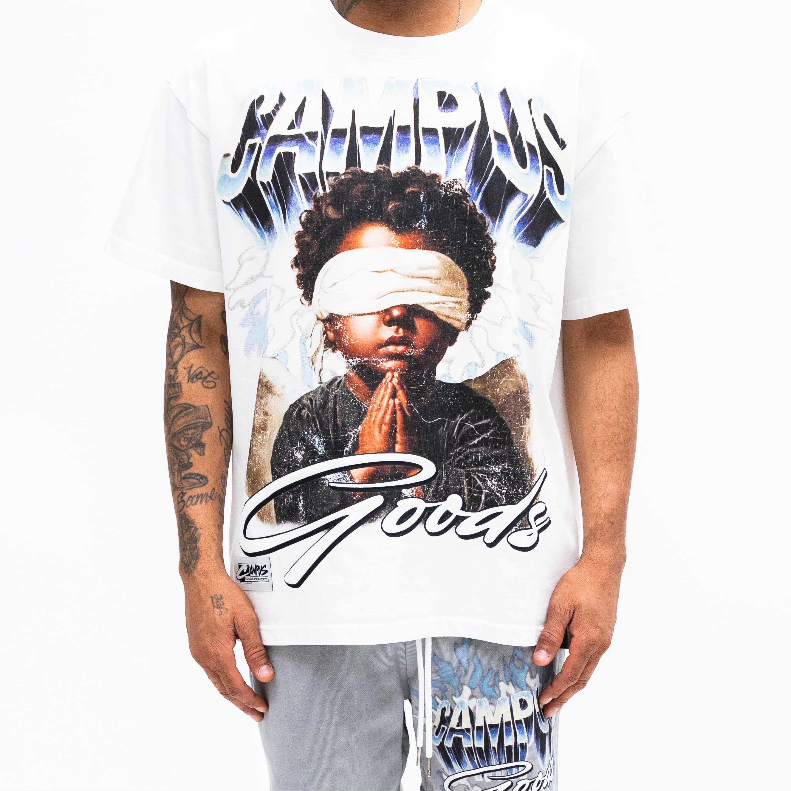 Man wearing a white t-shirt with a graphic design on a white background