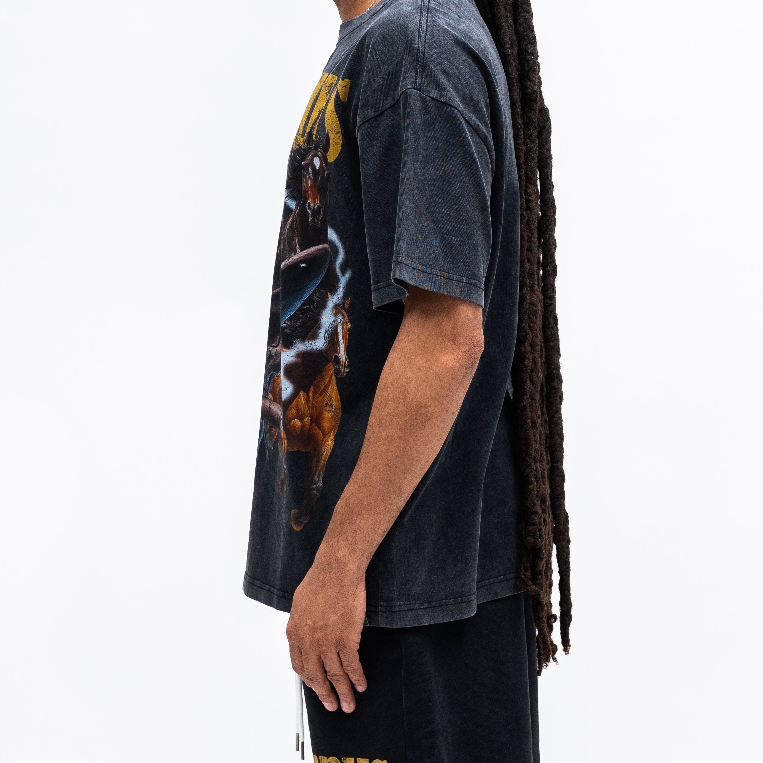Person wearing a graphic t-shirt with a colorful design on a white background