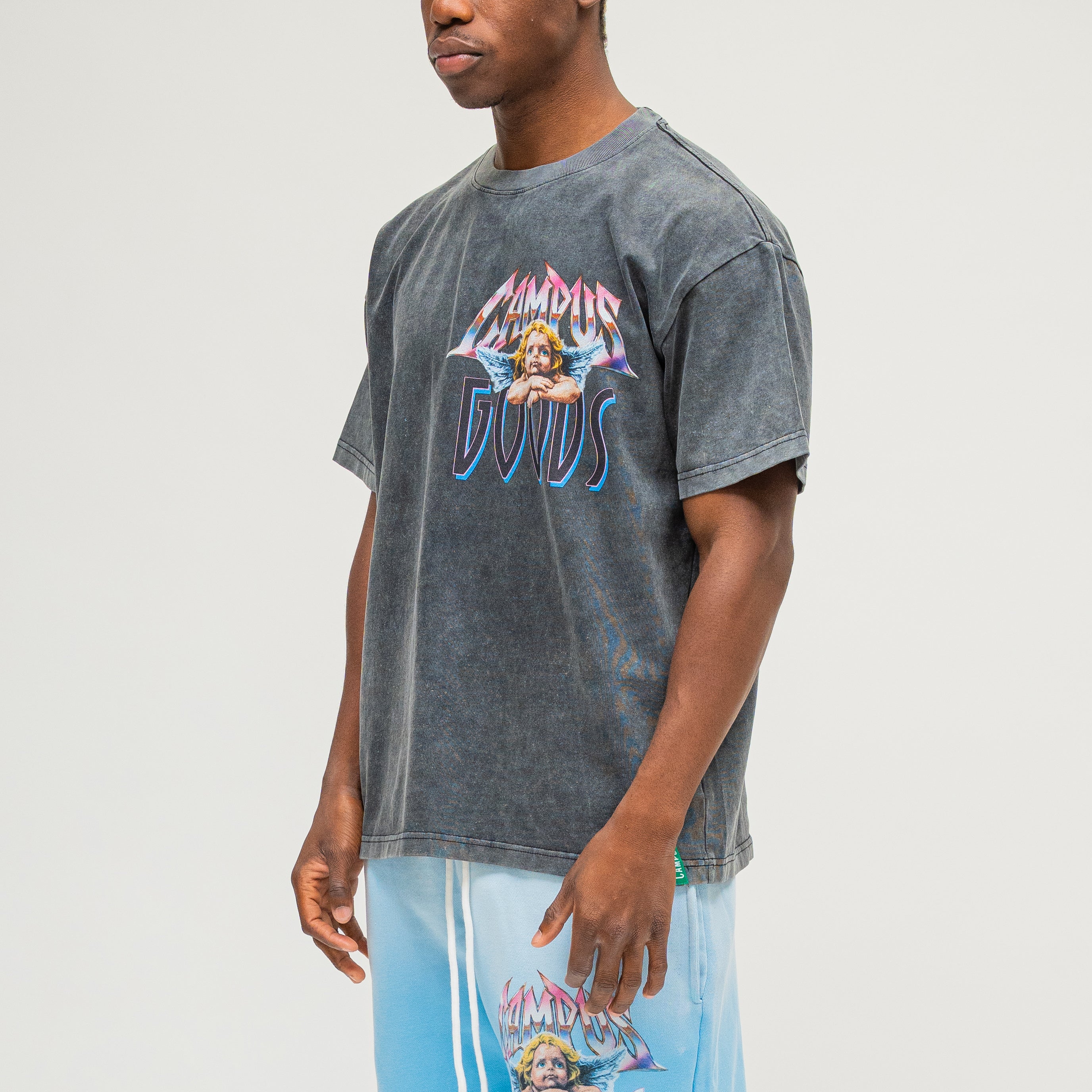Campus Goods LA Metallic Tee in black, three-quarter front view on male model showing angel cherub graphic and Campus Goods logo
