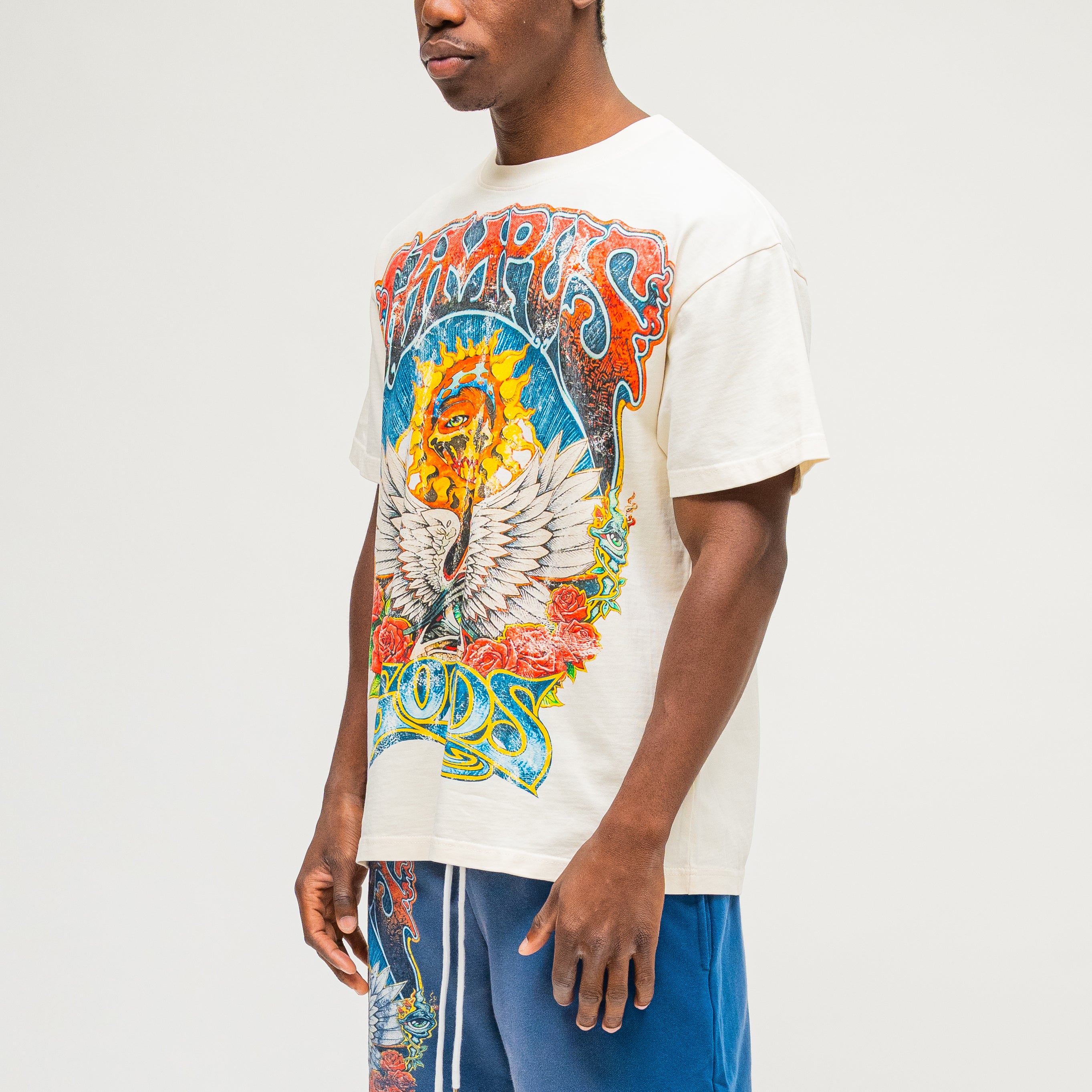 Campus Goods Psychedelic Tee in cream, side view with skull, wings, roses, and all-seeing eye graphic