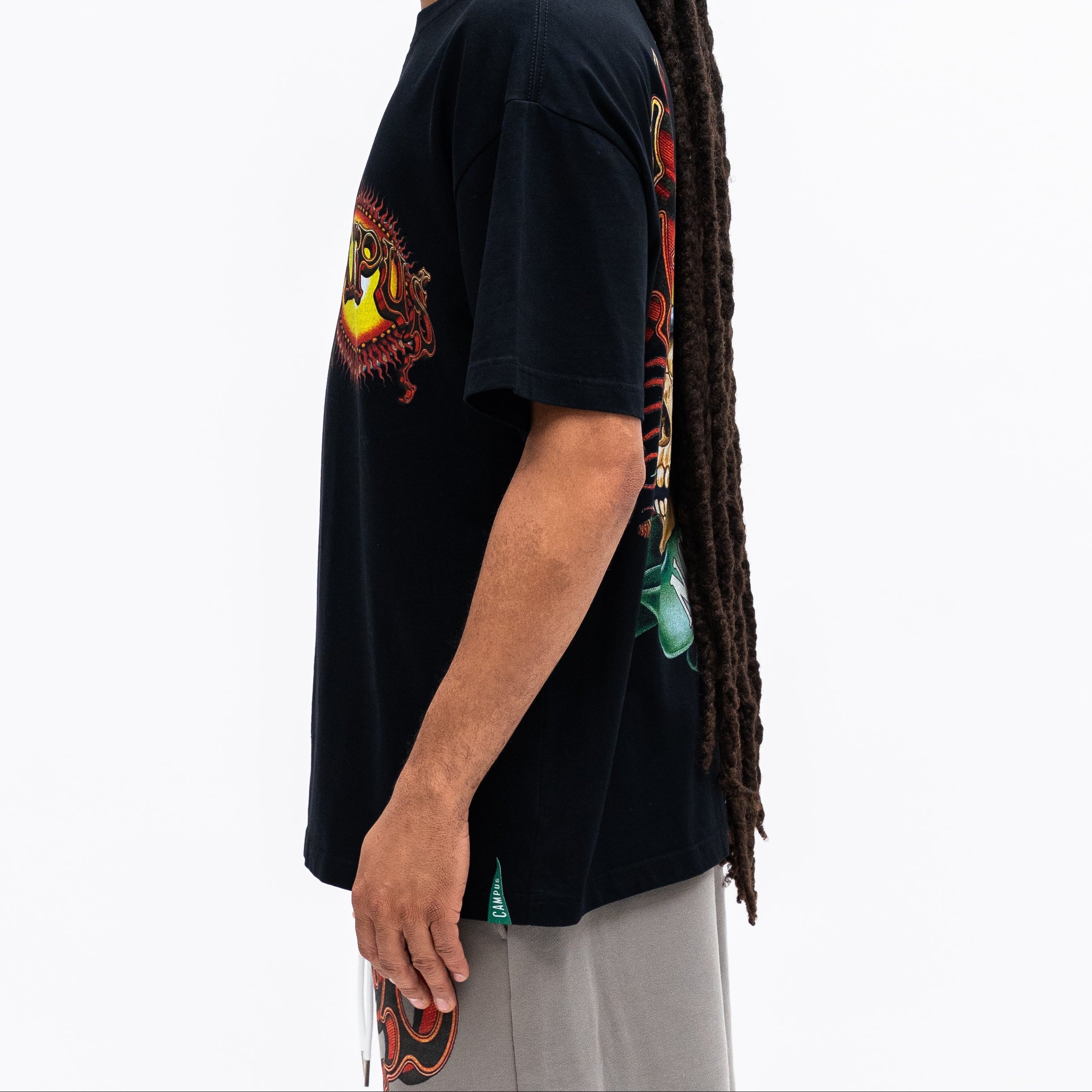 Person wearing a black t-shirt with colorful graphics on a white background