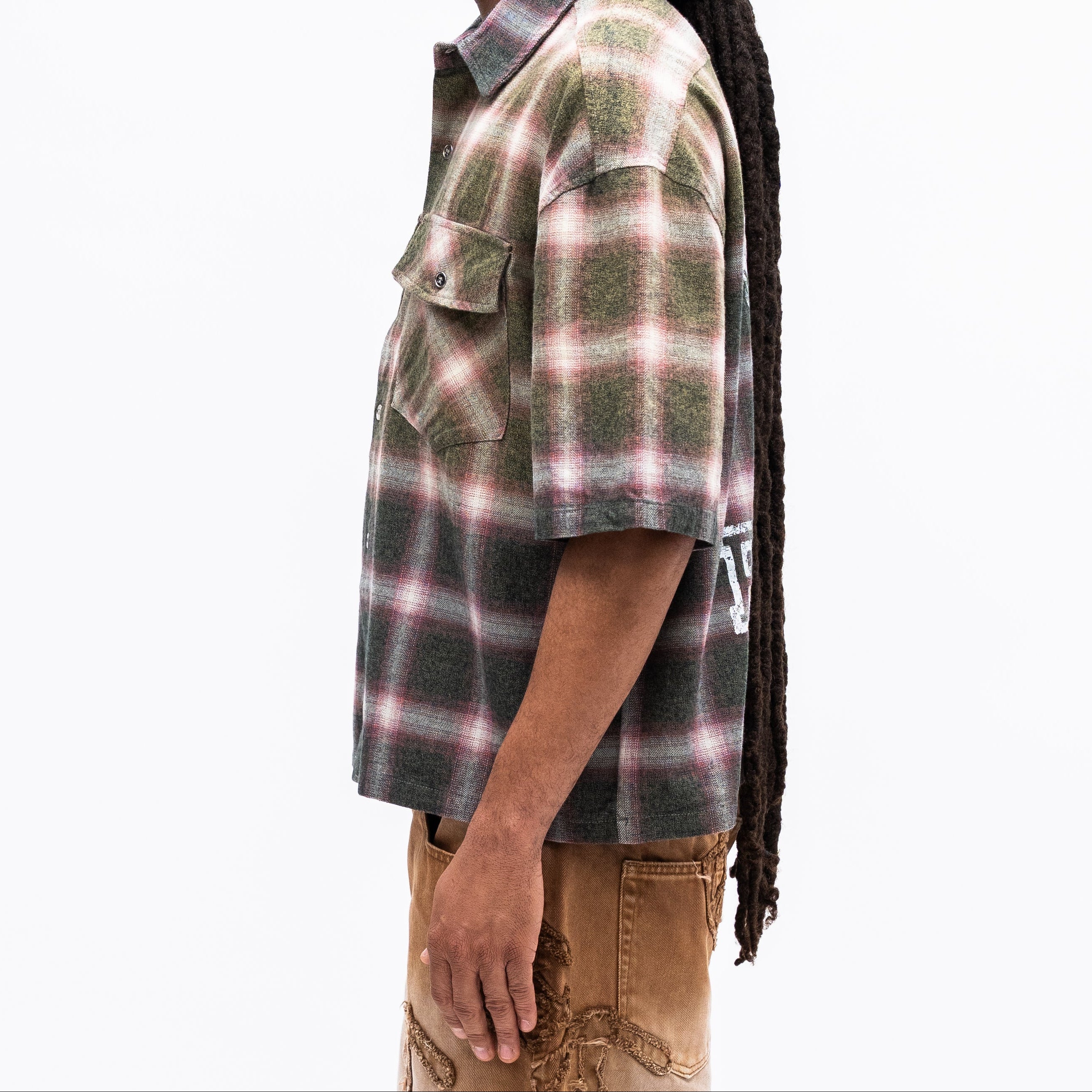 Person wearing a plaid shirt with a white background