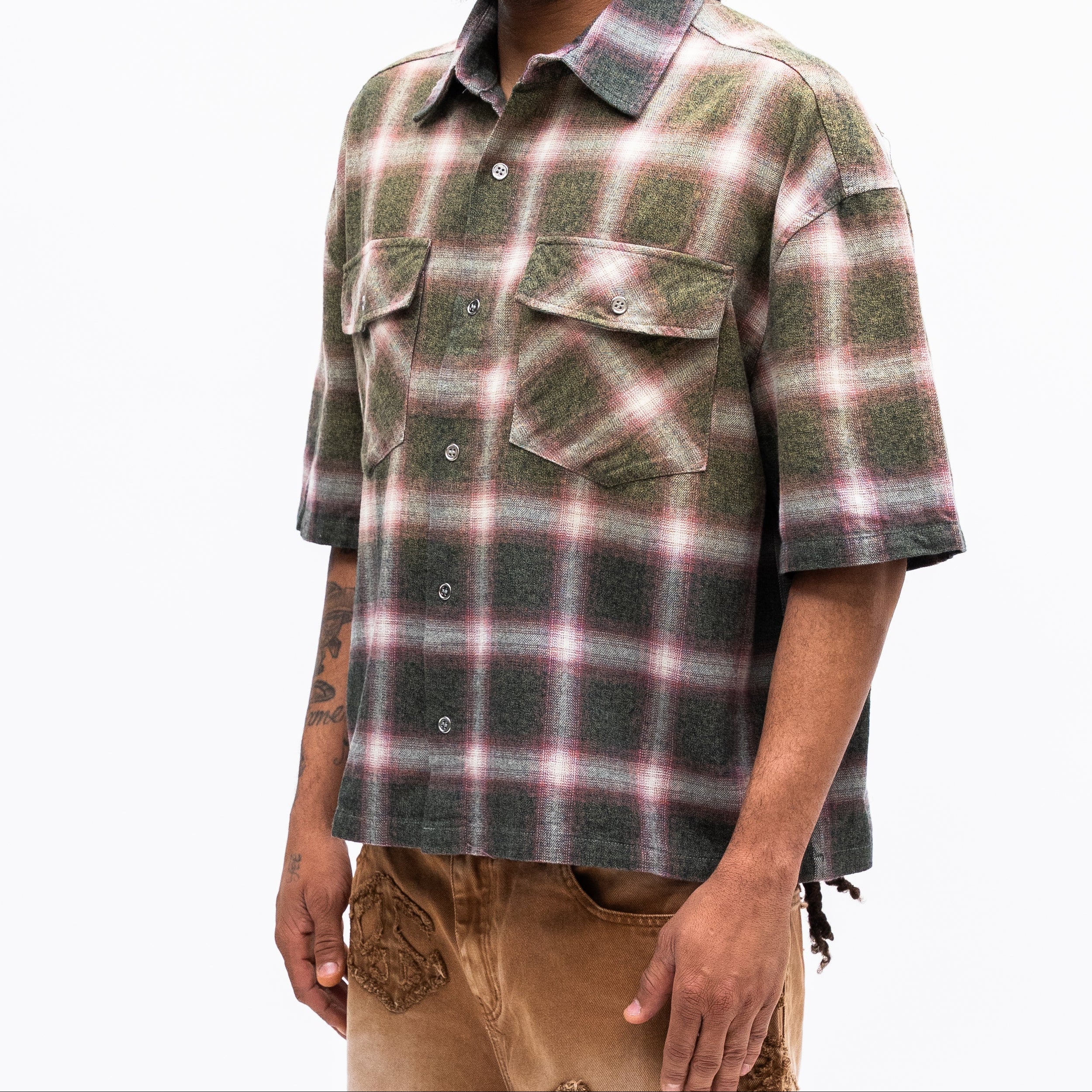 Man wearing a plaid shirt on a white background
