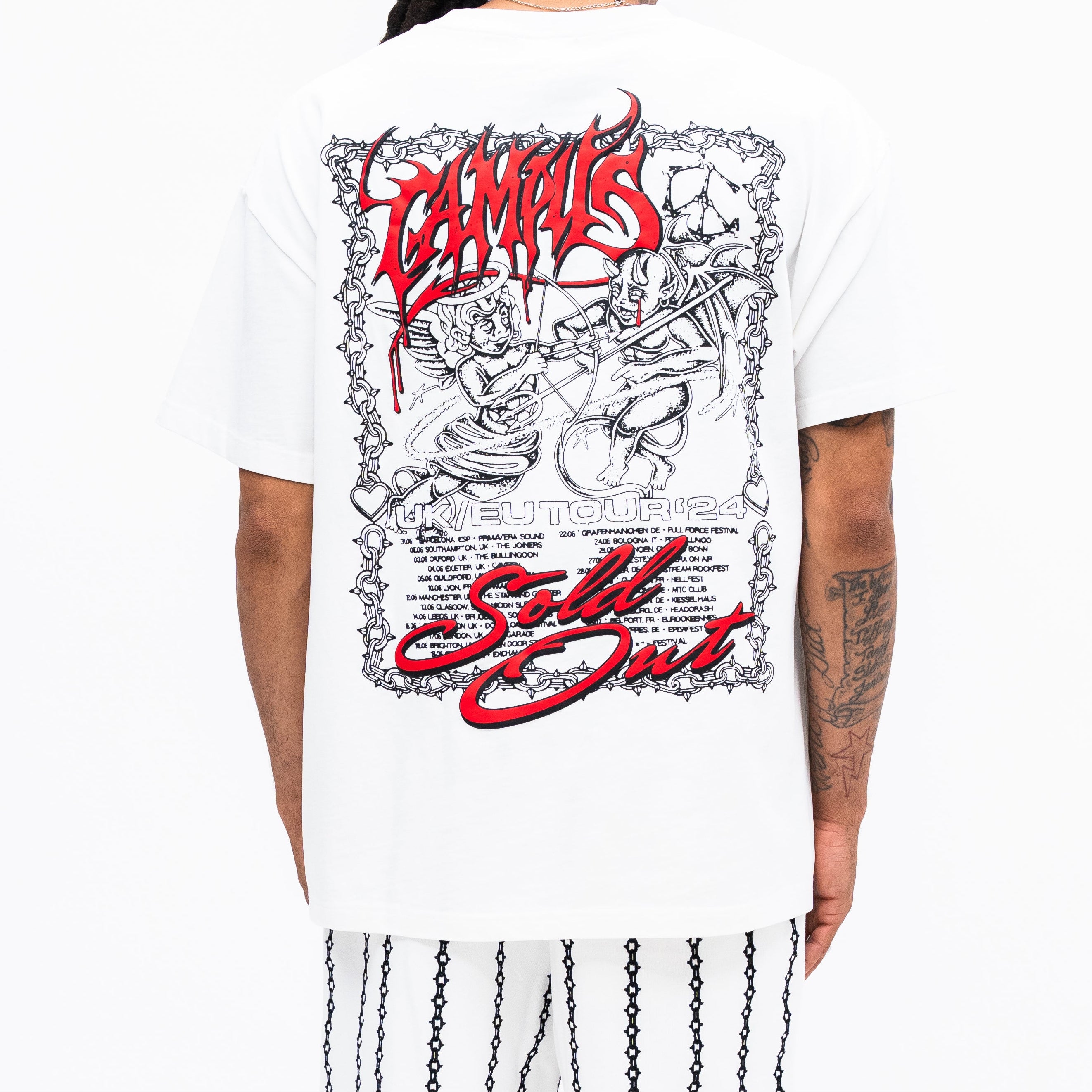 Person wearing a white t-shirt with red and black graphics and text on the back.